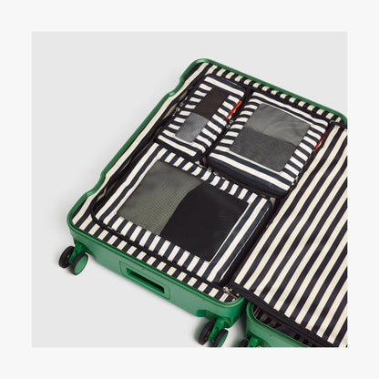 Set of Four / Poplin Stripe Black | Poplin Stripe Black compressible packing cubes neatly organized inside a Jungle Green suitcase